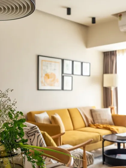 A different angle of the living room, showing the curated gallery wall and the comfortable, inviting sofa.
