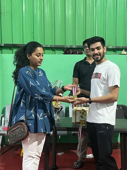 Presenting a medal during the awards ceremony for our internal singles league. I believe every participant's effort deserves to be celebrated at the end of a hard-fought tournament.