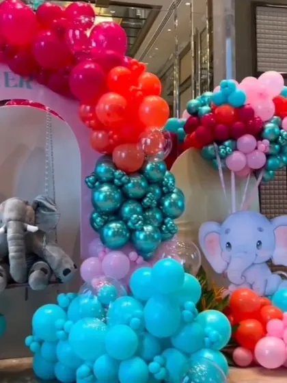 A close-up of the decor, highlighting the cute elephant cutouts and the mix of metallic and matte balloons.
