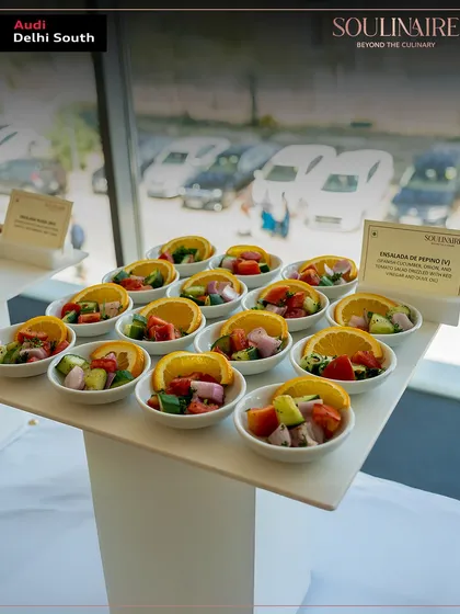 A fresh cucumber and orange salad served in individual portions at the Audi Delhi South event. We focus on fresh, seasonal ingredients in our corporate menus.