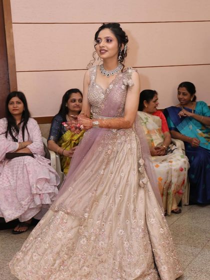 A full-length shot of the client in the lavender and silver lehenga, showing its beautiful flow and design.