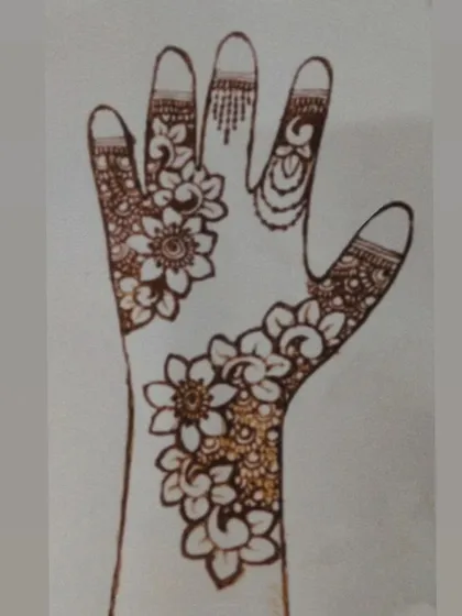 A design sketch on paper, mapping out a floral bail. This helps me perfect the flow and balance of the design before applying it to the skin.