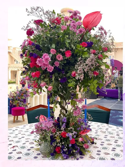 Another example of a vibrant, multi-colored floral centerpiece used for the peacock-themed welcome lunch.