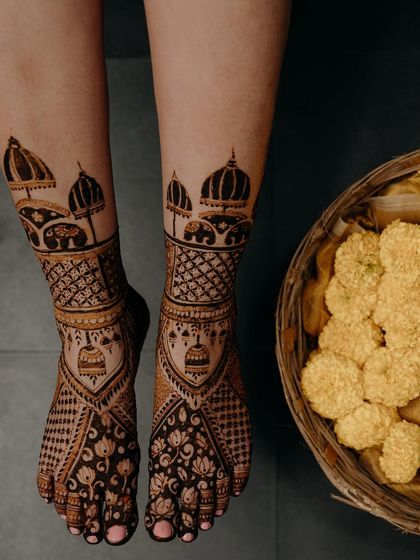 Another view of the ambari and jhumka feet design, this time with a basket of marigolds, adding to the festive wedding vibe.