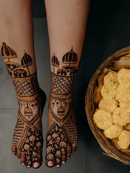 Another view of the ambari and jhumka feet design, this time with a basket of marigolds, adding to the festive wedding vibe.
