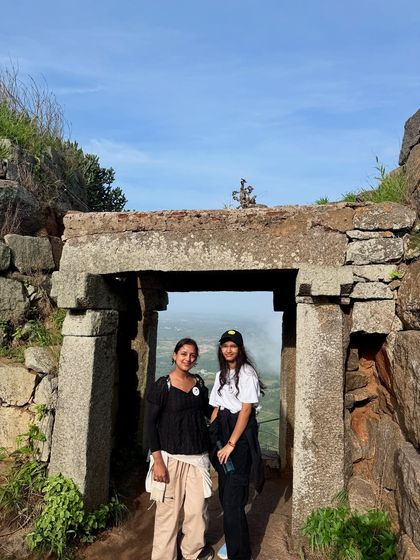 Posing at one of the seven ancient stone gateways on the Uttari Betta fort trail.