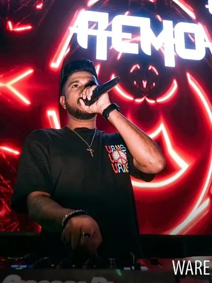 On the mic at Warehouse Cafe, with a vibrant red LED background. The lighting is always a key part of my performance.