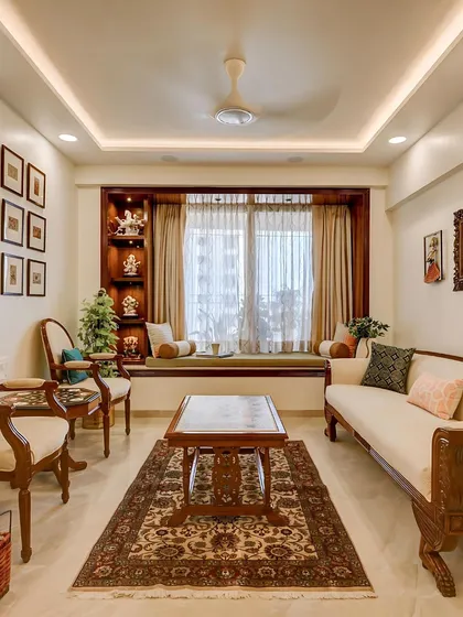 This living room is a celebration of classic Indian comfort and timeless design. Every element, from the custom-carved wooden furniture and handwoven rug to the curated gallery wall, was thoughtfully designed by me to create a warm, inviting, and personal family space.