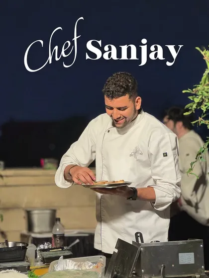 Meet Chef Sanjay, plating appetizers at an evening event. His attention to detail ensures every bite is perfect.