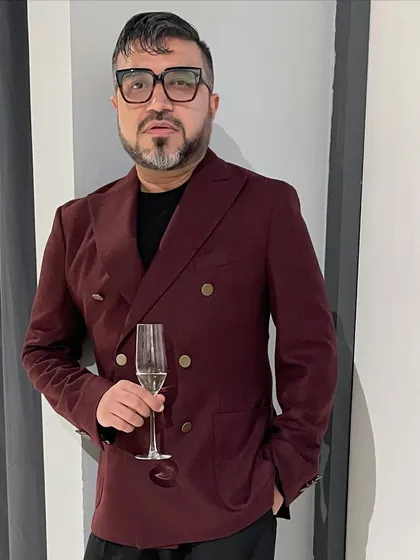 Attending a press event in a double-breasted wool jacket in a rich burgundy. It's a statement piece that instantly elevates a simple all-black outfit.