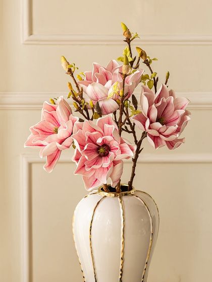 This artificial lotus magnolia stem features delicate pink and white blossoms that look incredibly realistic. It's an ideal choice for adding floral elegance to one of my modern vases.