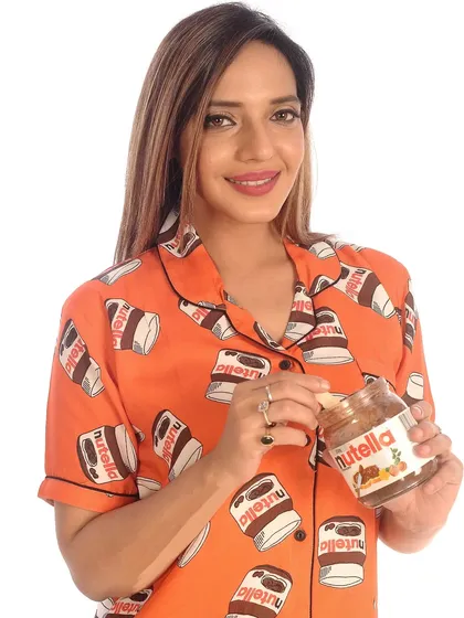 My Nutella print pajama set is a bestseller for a reason. This fun, vibrant orange design is printed on my signature butter-soft cotton, making it perfect for cozy nights and sweet dreams. It’s a playful nod to everyone's favorite chocolate hazelnut spread.