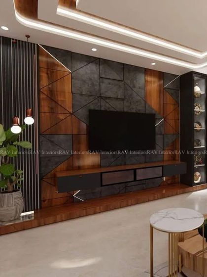 A wide-angle view of a modern living room, highlighting a geometric TV unit with integrated shelving. The design uses a mix of materials to create a sophisticated and contemporary entertainment space.
