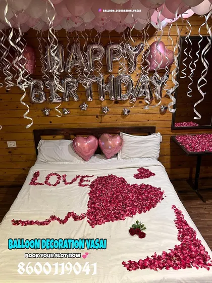 The full view of this farmhouse room decoration shows how the pink and white balloons and rose petal design create a soft and romantic contrast with the rustic setting.