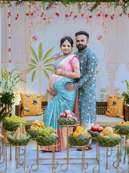 The happy couple, surrounded by traditional offerings and beautiful decor. Monika's pastel saree is a perfect choice for this joyous occasion.
