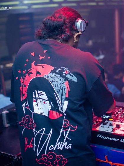 Lost in the rhythm. This shot captures me in my element, focused on the mix and feeling the music. The Itachi Uchiha shirt adds a personal touch.