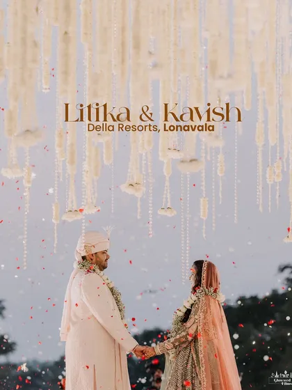 A classic, romantic portrait of Litika and Kavish after their varmala, set against the beautiful hanging floral decor of their Lonavala wedding.