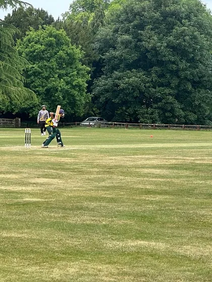 Hitesh in action, playing a shot during a match in the UK.