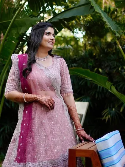 A beautiful candid shot of the bride. Her makeup is fresh and minimal, perfect for a daytime engagement ceremony.