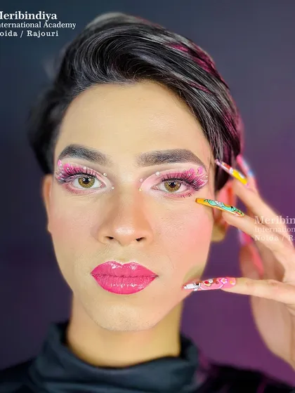 This image highlights the harmony between the vibrant pink makeup and the detailed, multi-character nail art, a skill valuable for editorial and fashion work.