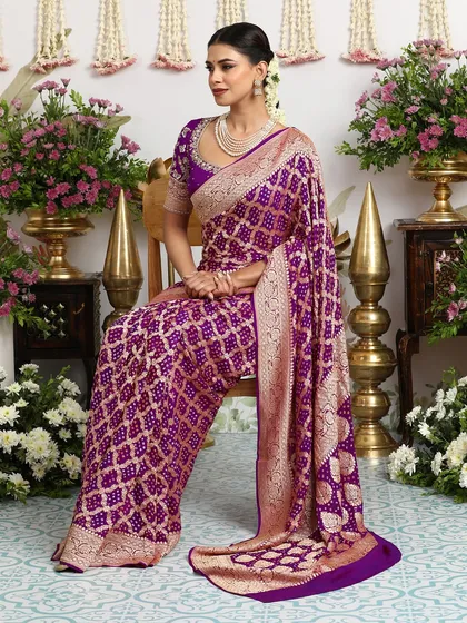 A seated portrait in the royal purple Banarasi Bandhani saree, showcasing its rich pallu and intricate zari border.