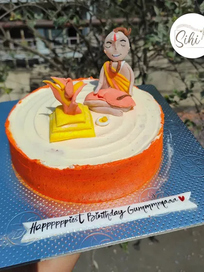 Praying for more cakes. This unique cake features a hand-sculpted fondant figurine of a priest performing a ritual, created for a special birthday.