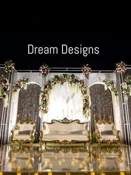 A full view of the sensational iced backdrop stage. The combination of cool-toned structures, warm floral accents, and a candlelit floor creates a design that is both dramatic and romantic.