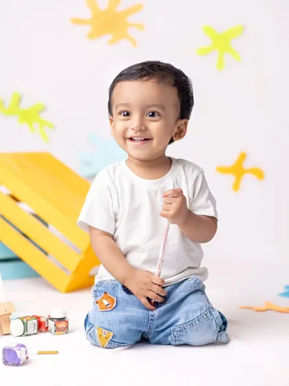 Our cutest little artist creating a masterpiece. This fun, colorful setup is all about encouraging creativity and capturing joyful smiles.
