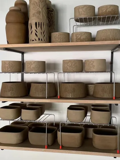 A look at our shelves, packed with student greenware. Using our little wire rack "jugaad" helps us manage the constant flow of work in a busy studio.
