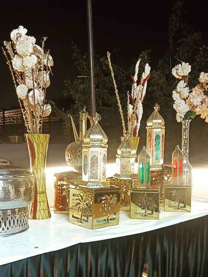 Beautiful table decor featuring Moroccan lanterns and dried floral arrangements, adding a unique touch to the buffet line.