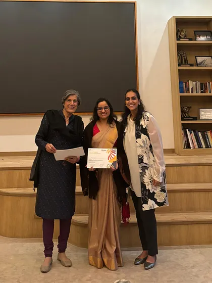 An educator in a beautiful saree receives her leadership certificate. This image reflects the diversity and dedication of our team, who are all committed to lifelong learning.