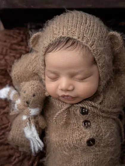 So tiny, so sleepy, and so very loved. This little one, dressed as a cuddly bear, is peacefully dreaming with his tiny teddy friend.