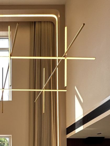 A detail of the striking linear chandelier in the double-height living space, which acts as a sculptural element while providing ambient light.