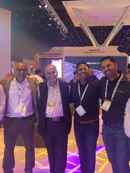 Our team networking with industry partners and clients at a professional trade show. We prioritize building strong relationships and staying connected with the latest innovations in event technology.