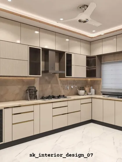 A spacious L-shaped kitchen with textured and plain laminates. The design includes a tall unit for appliances and a well-lit countertop for food preparation.