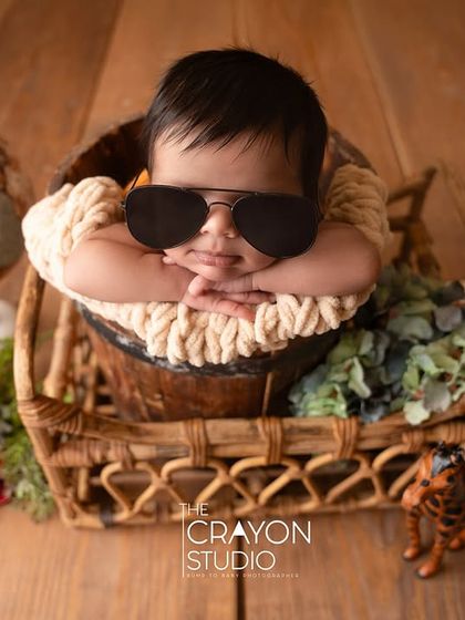 A bit of fun and personality with this cool little dude. A newborn wearing sunglasses, looking like the world's most relaxed traveler.
