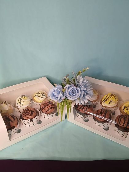 Cupcake boxes are another wonderful option for Rakhi gifting. Here are two boxes of six cupcakes each, featuring a mix of chocolate and vanilla flavors, beautifully arranged and ready to be delivered.
