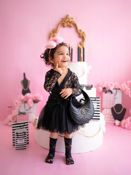 A thoughtful pose with her designer bag. This little girl knows how to work the camera.