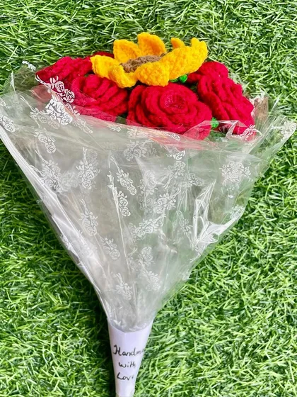 A lovely Valentine's bouquet with classic red roses and a single, bright sunflower in the middle. A beautiful combination of love and happiness.