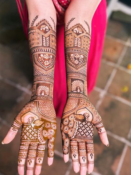 Another shot of the peacock design, highlighting the symmetry and the graceful flow of the patterns from the fingers to the arms.