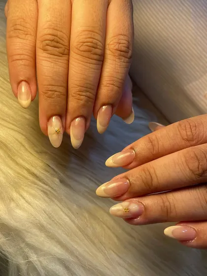 A cute and simple summer nail design. This set features a soft, milky ombré with a tiny, hand-painted floral accent for a touch of minimalist charm.