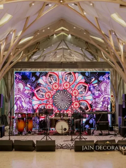 The venue's unique architecture is the star here, enhanced by a vibrant LED screen backdrop for the band. It's about blending the decor with the space to create something truly special.