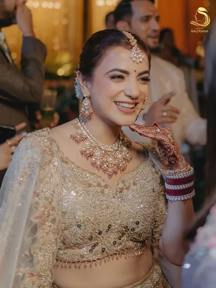 A candid moment of the bride, her smile as bright as her look, complete with the elegant floral bun.