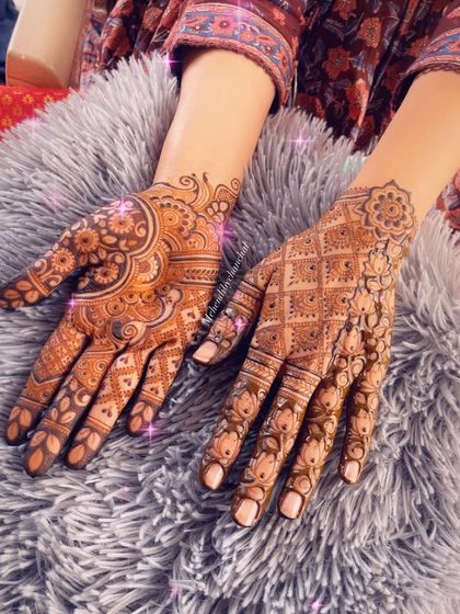 This design shows two different styles for each hand, a popular trend. One hand has a dense, traditional Indian pattern, while the other features a more spacious Indo-Arabic design.