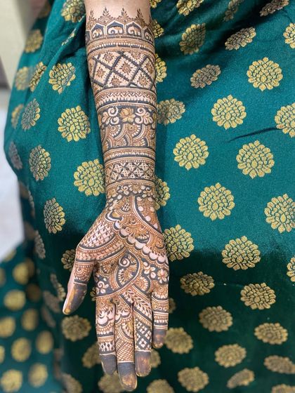 A full view of a bridal arm, showcasing the beautiful flow of the design from wrist to elbow.