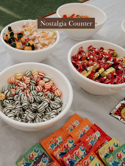 A touch of nostalgia. We set up this counter with candies from the 90s, taking guests on a sweet trip down memory lane. It's these small, personal touches that make a wedding memorable.