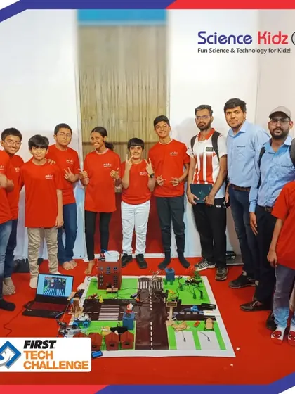 Our full First Tech Challenge team stands proudly with their mentors and their award-winning "Soul City" project. This photo represents the collective effort that led to their success at the national championship.