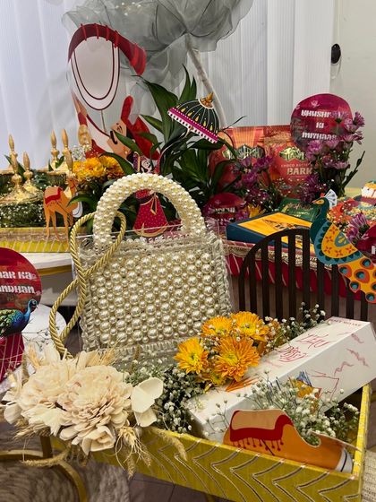 A side view of the Rakhi trousseau, highlighting the beautiful pearl-handled bag included in the gift.