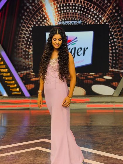 A full-length view of my lavender gown for an episode. The elegant silhouette was chosen to create a striking presence on the grandly lit stage.