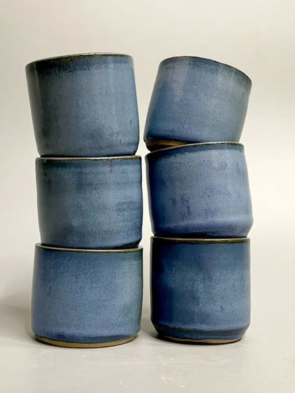 A stack of the rustic blue tumblers. The elegance of the form combined with the unique glaze makes each piece extraordinary.